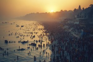 Devotees gather for a holy dip at the Ganges River during sunrise in Varanasi, India, showcasing vibrant spiritual rituals and traditional Indian architecture along the ghats.